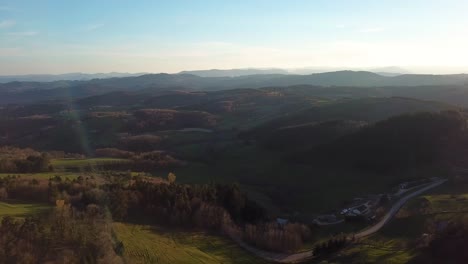 drone view of french countryside with forest and hills in ardèche under the sunset