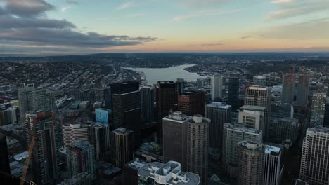 aerial above downtown seattle skyscrapers toward lake union with clouds and sky