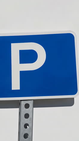 blue parking sign with white p symbol