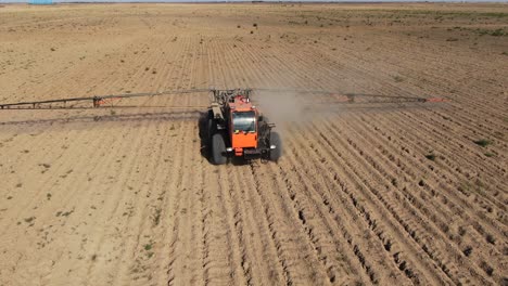 Agricultural-Boom-Sprayer-Driving-On-Dusty-Field-On-Countryside-Near-City-Of-Kyiv-In-Ukraine