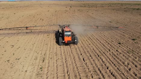 agricultural boom sprayer driving on dusty field on countryside near city of kyiv in ukraine