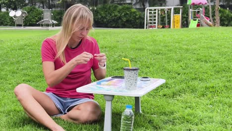 woman beading outdoors