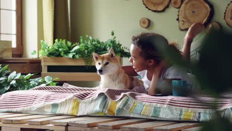 girl and dog relaxing on a bed