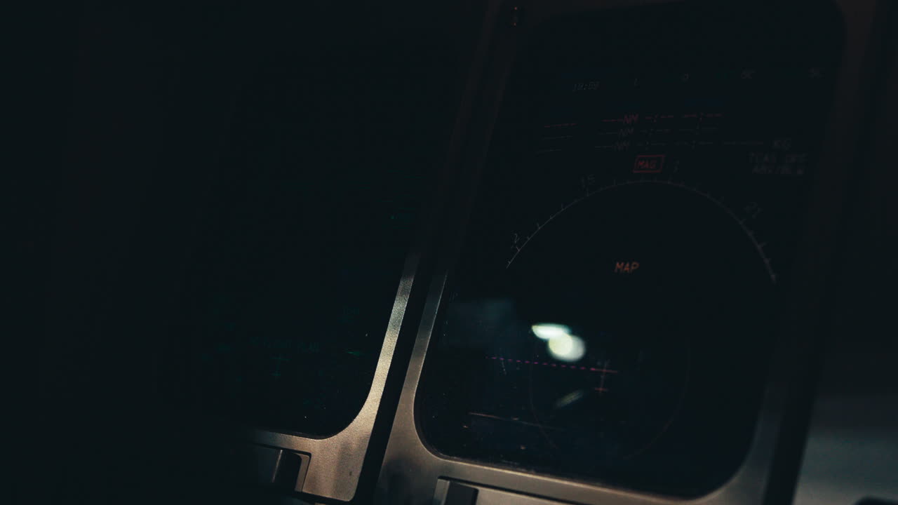Aircraft cockpit instruments turned on and becoming to life in dark cockpit environment