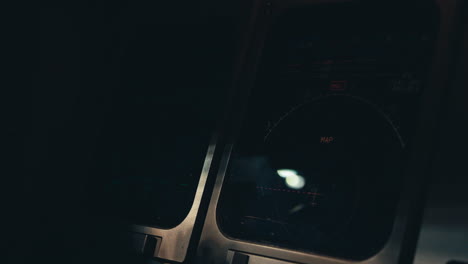 aircraft cockpit instruments turned on and becoming to life in dark cockpit environment