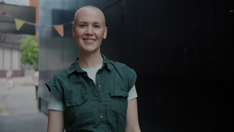 smiling bald woman in city alley