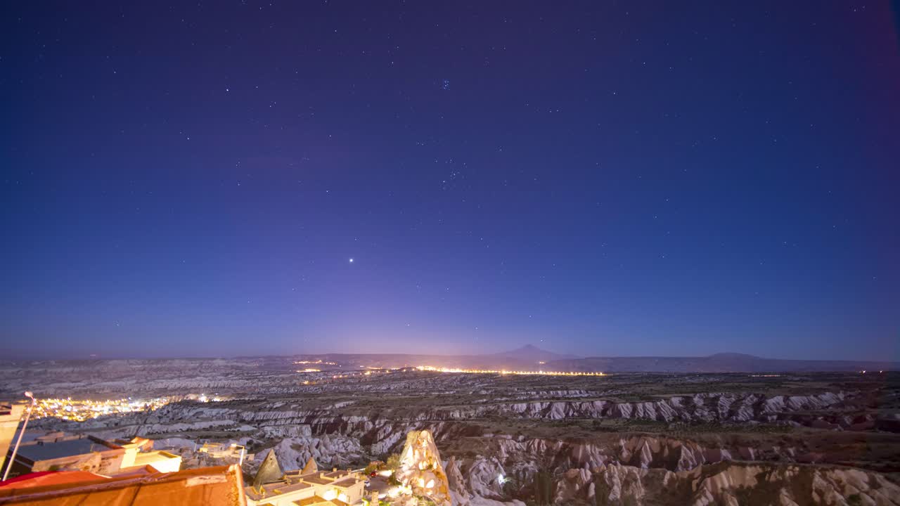 Night to day timelapse in Iceland with moon and sun rising over rocky landscape