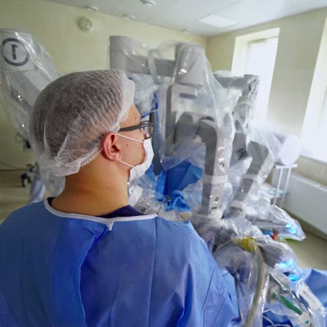 modern surgery by medical robot. doctor near the surgical arms of futuristic robotic machine. medical robot performing a surgery in clinic. high technologies in medicine