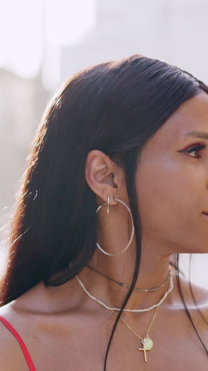 Close-up portrait of a person with striking makeup and jewelry