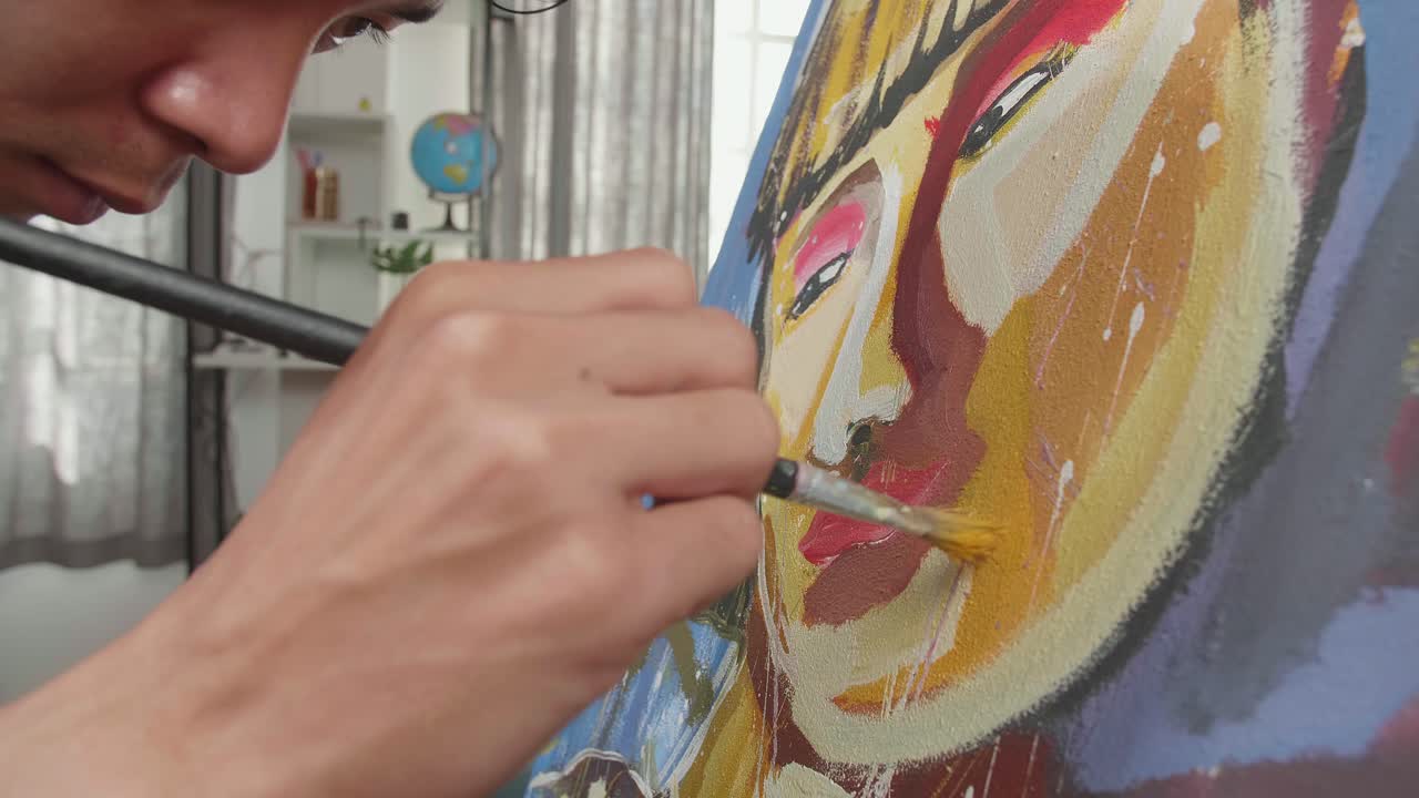 Close Up Of An Asian Artist Man Holding Paintbrush Mixed Colour And Painting A Girl'S Face On The Canvas