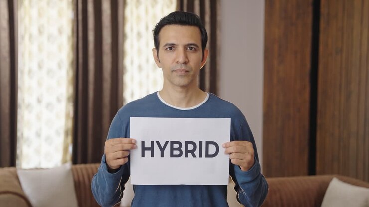 Indian man holding HYBRID banner