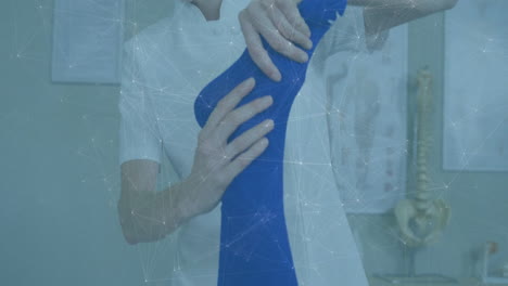 physiotherapist supporting patient leg in medical clinic, overlaying animated knee anatomy chart