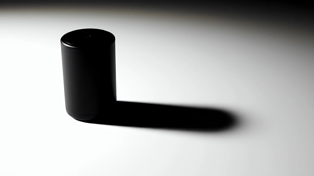 Black Cylindrical Object Casting a Long Shadow on White Surface