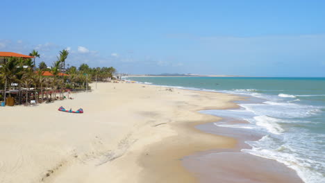 Aerial-view-of-the-sea,-waves-and-a-small-village,-Cumbuco,-Ceara,-Brazil