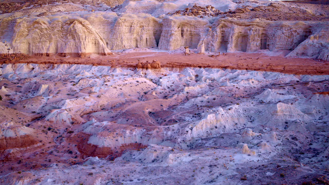 Drone glides above toadstool hoodoos, unveiling a dreamlike mix of color and stone.