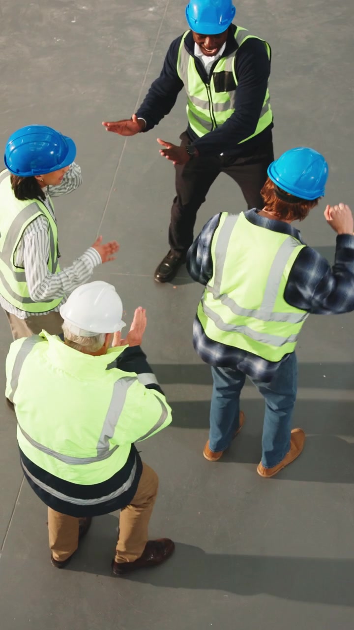 Construction Workers Celebrating and Dancing Together on Site