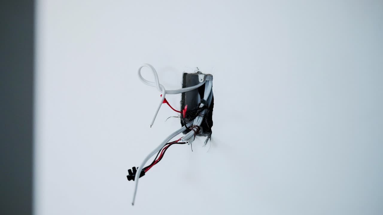 Electrical cables sticking out of a wall where a socket or plug will be wired to