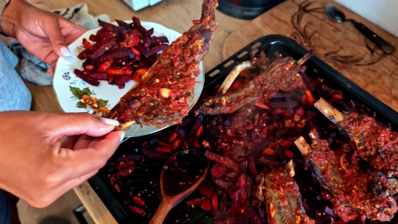 Female hand Plating Roasted Meat Ribs and Vegetables in a Rustic Kitchen Setting