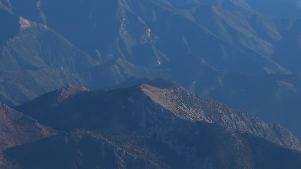 View from an airplane window of a mountain range
