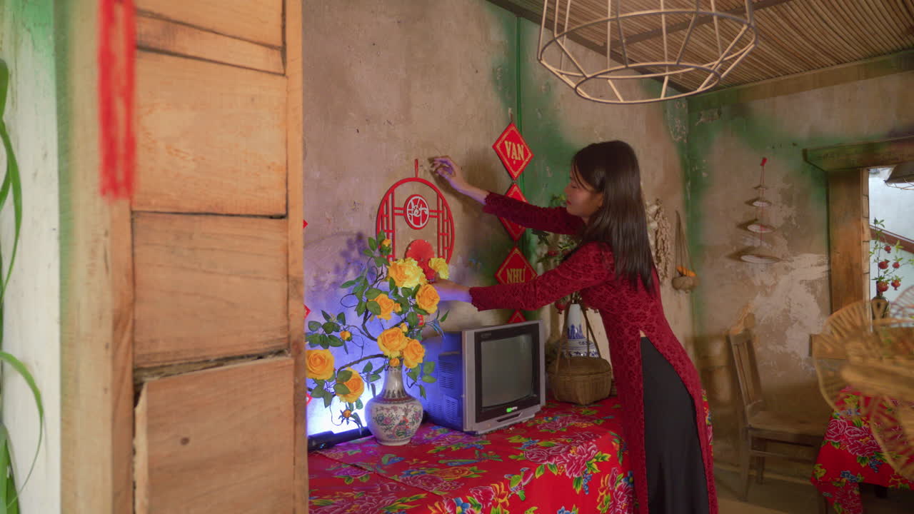 Chinese New Year celebration , housewife in traditional clothing cleaning the house before the event celebration holiday family gathering party