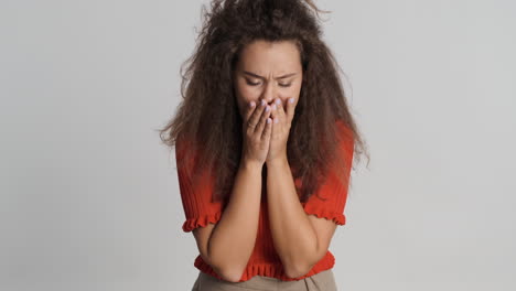 Caucasian-curly-haired-woman-coughing-in-front-of-the-camera.