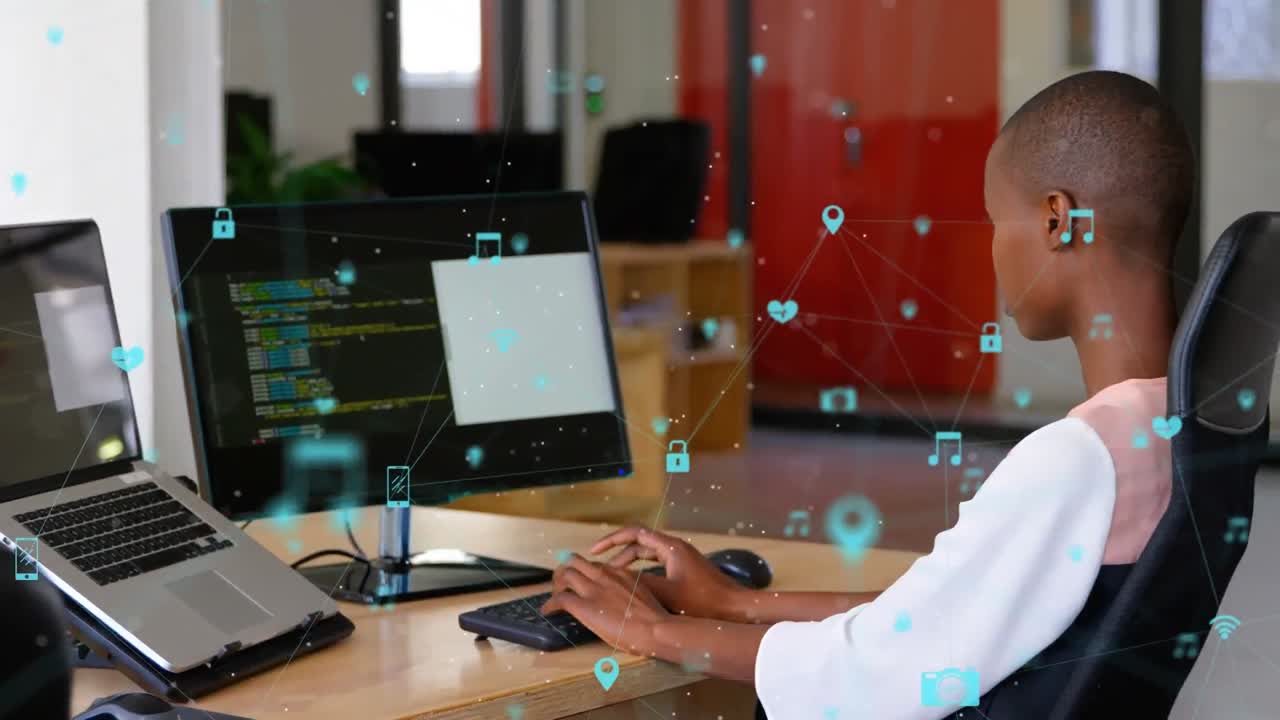 Animation of connected icons over african american woman working on computer at office
