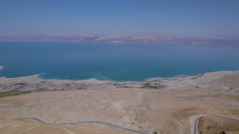 Dead-Sea-from-a-high-altitude-from-a-drone-and-a-road-to-the-mountains-below