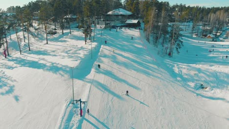 people-ski-and-snowboard-on-mountain-resort-track-upper-view