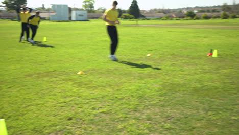 team of multiracial male cricket players practicing cricket on pitch
