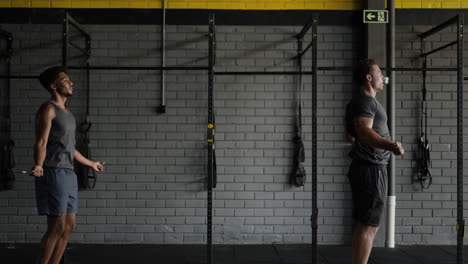 two men jumping rope in a gym