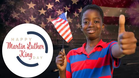 animation of happy martin luther king day text over happy african american boy with american flag