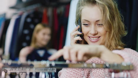 young woman chooses chothes in women's clothing store 2