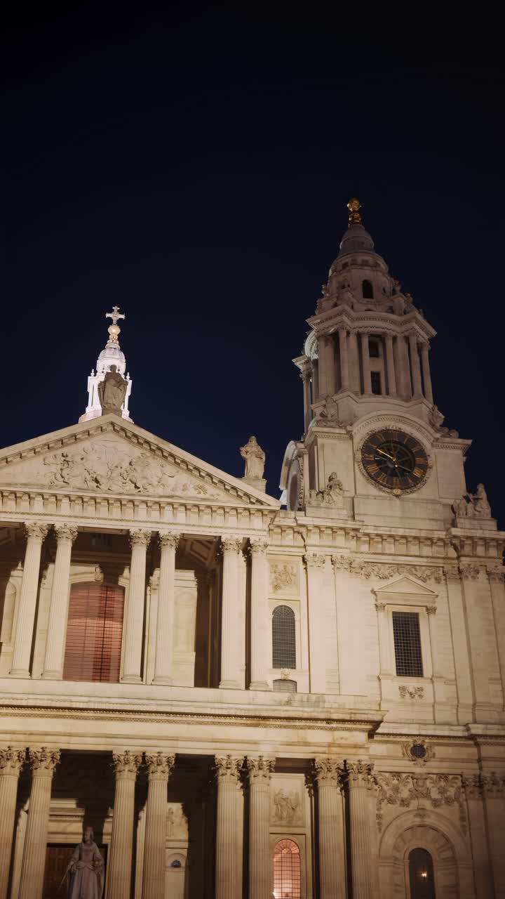 The Dome of St. Paul's Cathedral trees with the night sky in the background in London, England. Vertical