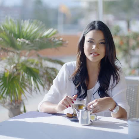 Girl-Sitting-At-Cafe-With-Cup-Of-Tea