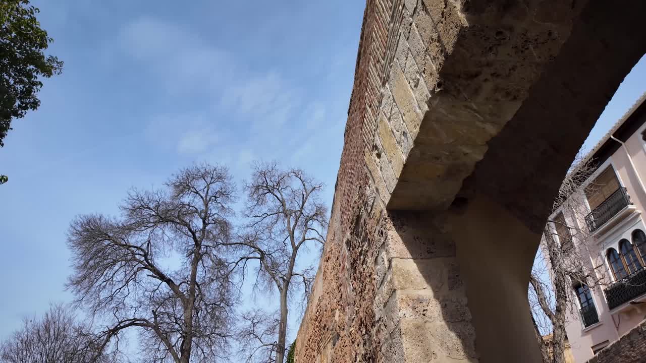 Panoramic and detail shot of the entrance opening to the monumental complex of the Alhambra in the city of Granada, Spain