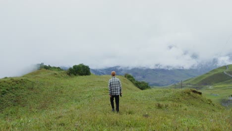 man hiking in misty mountains