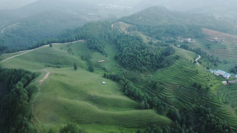 aerial-view-of-grassland-middle-of-forest-in-Kulekhani,-Nepal