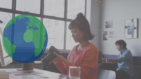 animation of globe over asian businesswoman working at office