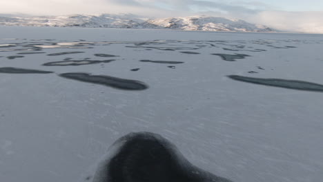 Ice-frozen-lake-and-breathtaking-mountains-at-sunrise,-Iceland