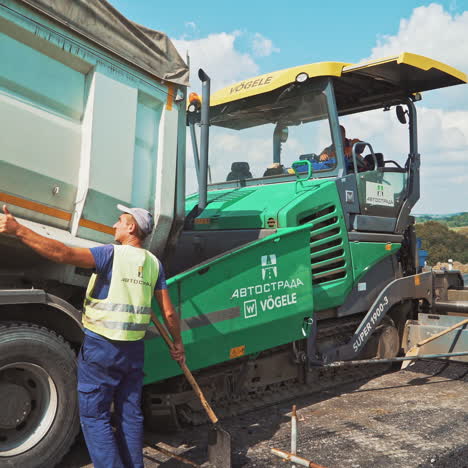 industrial machinery on a road construction site. roadworks at laying new asphalt. paving machine laying fresh asphalt on a highway.