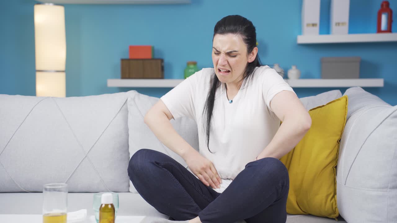 Woman experiencing stomachache.