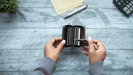 man hand taking credit card out from a wallet