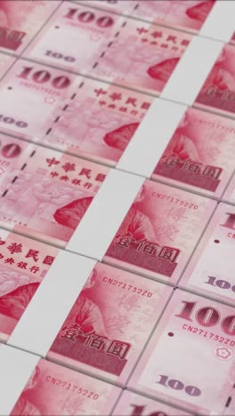 vertical video of 100 new taiwan dollar banknotes printed by a money press