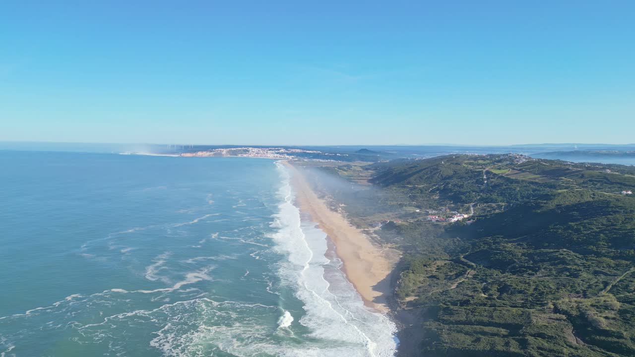 Long stretch of golden beach seen from Miradouro do Salgado, Nazaré, Portugal