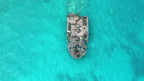 Top-View-Of-A-Rusty-Shipwreck-Over-The-Blue-Sea-Of-San-Andres-Island,-Colombia