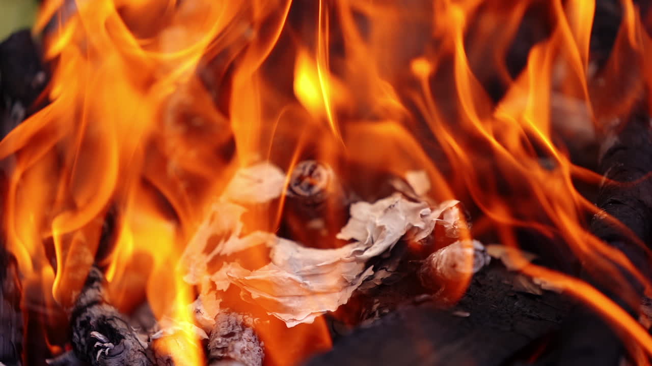 Red and yellow flame. Vivid fire background. Wood burning in bright fire for barbecue. Detailed motion of fire.