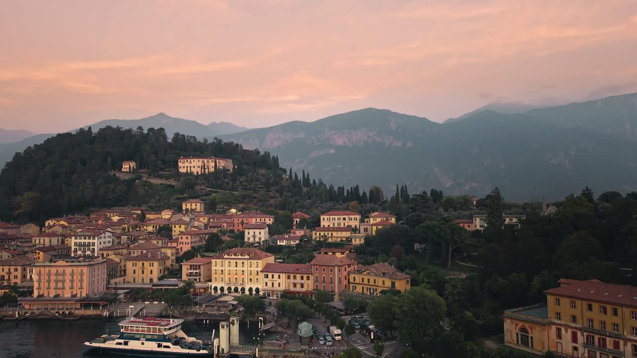 A mesmerizing drone shot of Bellagio on Lake Como during sunset. The drone ascends diagonally while panning from left to right, highlighting the charming town and the stunning panoramic lake backdrop.