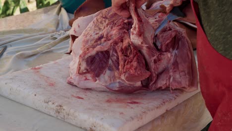 cutting pork shoulder with knife during rural butchering in north portugal minho