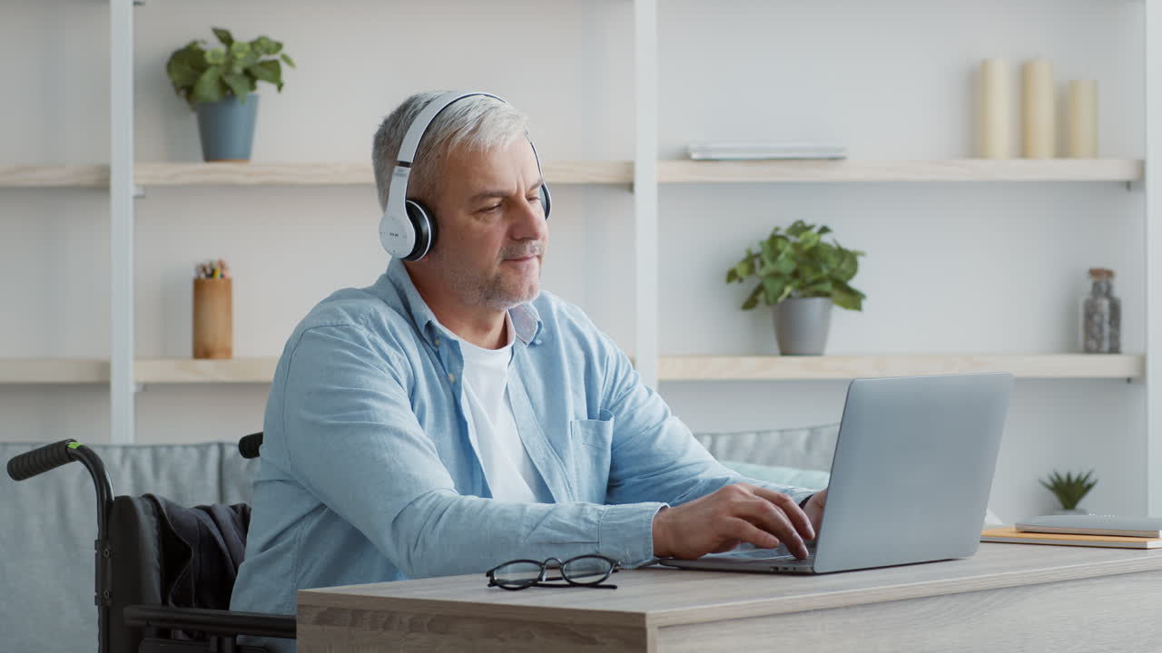 Man in Wheelchair using Laptop in Video Call