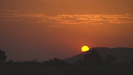 sun setting behind hills of gwalior